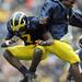 Michigan quarterbacks Denard Robinson, right, and Devin Gardner celebrate after Gardiner scored a fourth quarter touchdown for the Wolverines in their 65-21 thumping of Bowling Green State University,  Saturday, September 25th at Michigan Stadium. 
Lon Horwedel | AnnArbor.com
